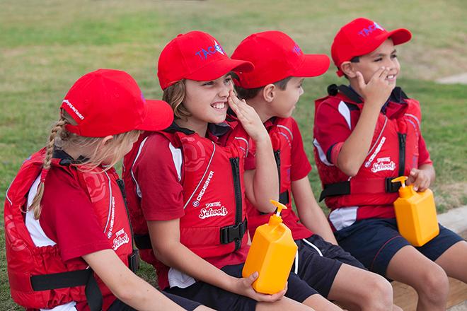 Sporting Schools Tackers applying sunscreen before learning to sail. &copy; Jane Gordon